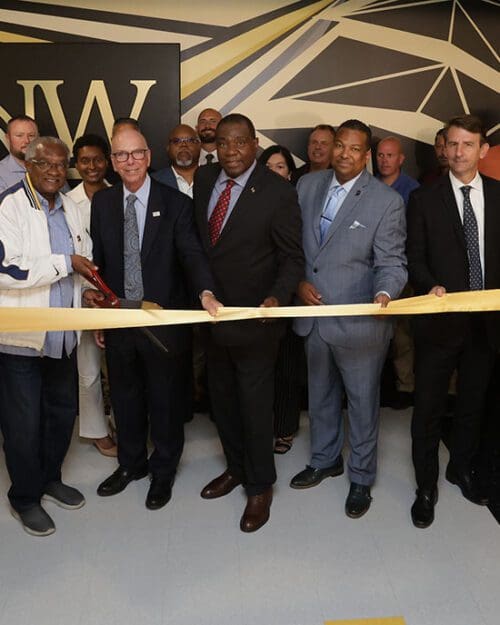 People gather during a ribbon-cutting on PNW's campus