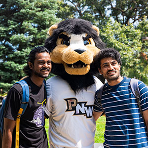 Two students pose with Leo the Lion