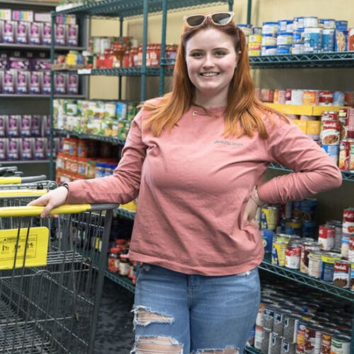 A student stands in the PNW food pantry