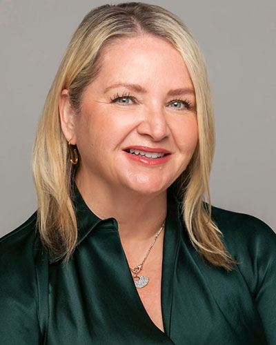 Professional portrait of Nicole Kupchik in a green shirt