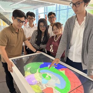 Students stand around PNW's Anatomage table