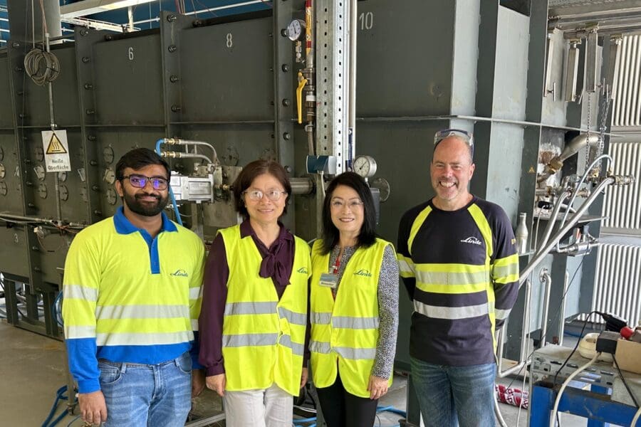 4 people standing in a steel plant