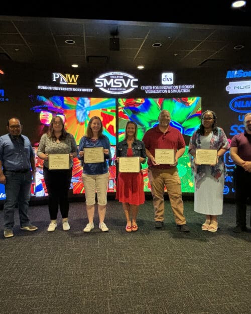 group of teachers holding certificates