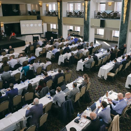 picture of large crowd watching panel discussion