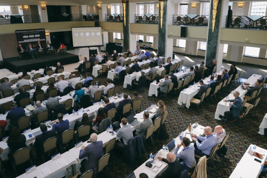 picture of large crowd watching panel discussion