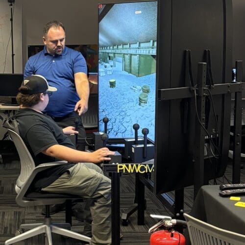 student demonstrating crane simulator