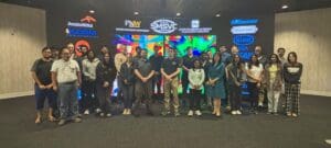 group of people standing in front of theater screen