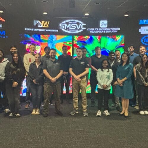 group of people standing in front of theater screen