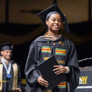 A PNW student crosses the stage with her degree