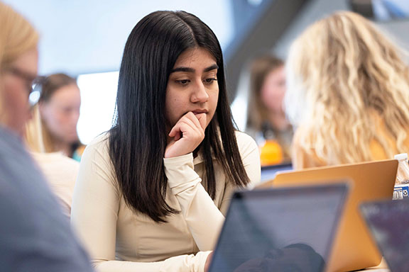 A PNW nursing student looks at a laptop