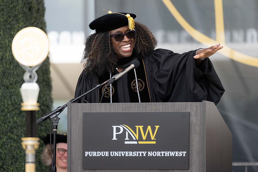 Regina Biddings-Muro stands onstage and gives the spring 2024 commencement keynote
