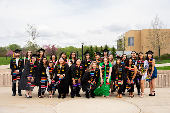 Spring 2024 Latino graduates pose together during a commencement celebration at Westville.