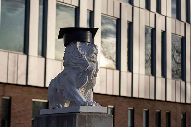 A PNW lion statute in commencement regalia