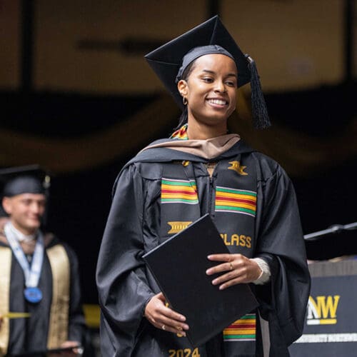 A PNW graduate crosses the stage with her degree