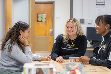 Three students sit in the tutoring center