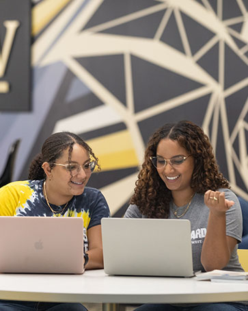 PNW students collaborate around a computer