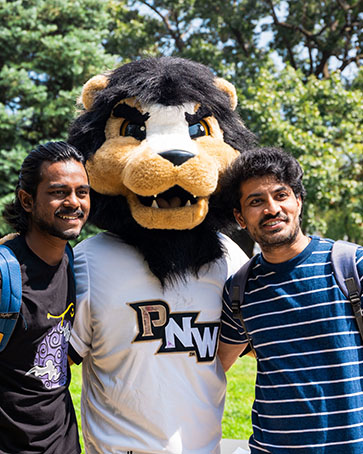 Two students pose with Leo the Lion