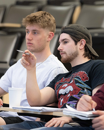 Two students sit in a lecture room