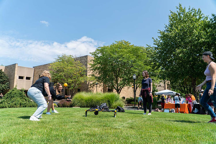 Students playing bean-bag toss