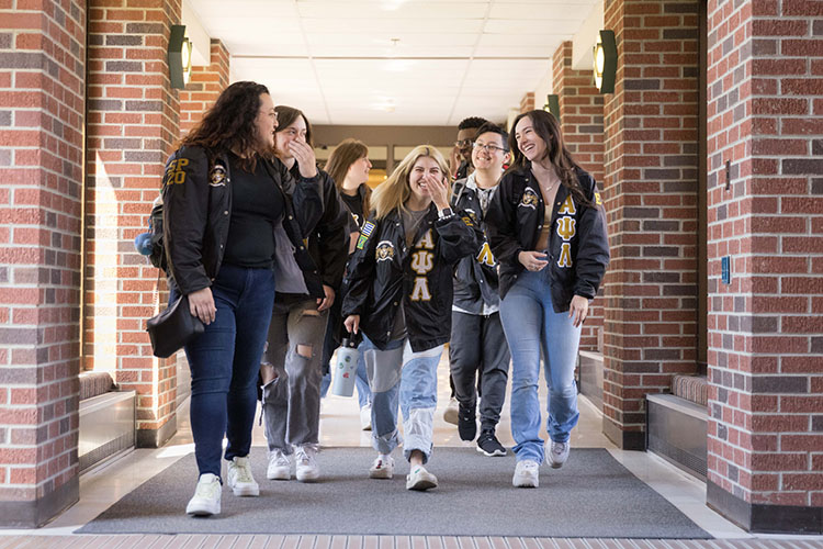 Un grupo de estudiantes camina por un pasillo.