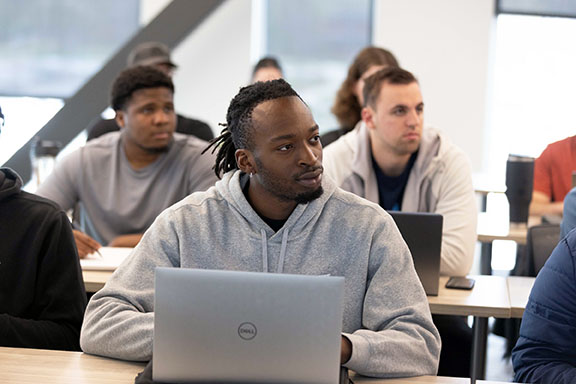 PNW students work on laptops in a classroom