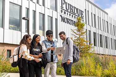 Four students stand outside the Nils K. Nelson Bioscience Innovation Building