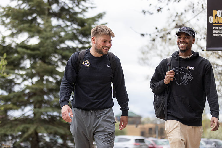 Two students walk together outdoors