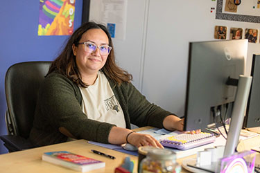 A staff member works at a computer