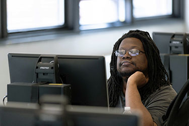 A person sits at a computer