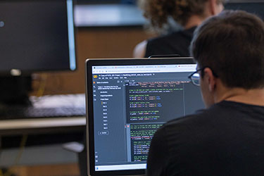 A PNW student codes in a computer classroom