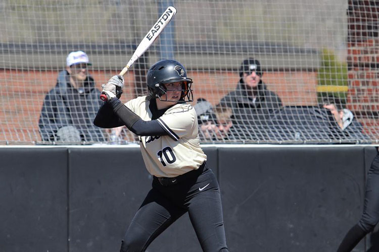 PNW Softball member gets ready to hit the ball with bat.