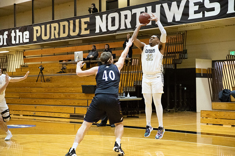 A PNW men's basketball player mid-shot