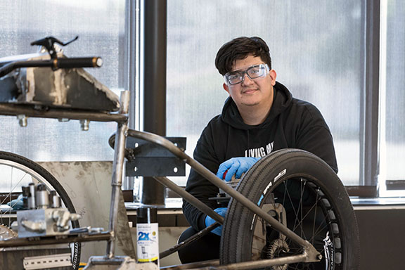A PNW student works on an electric bike