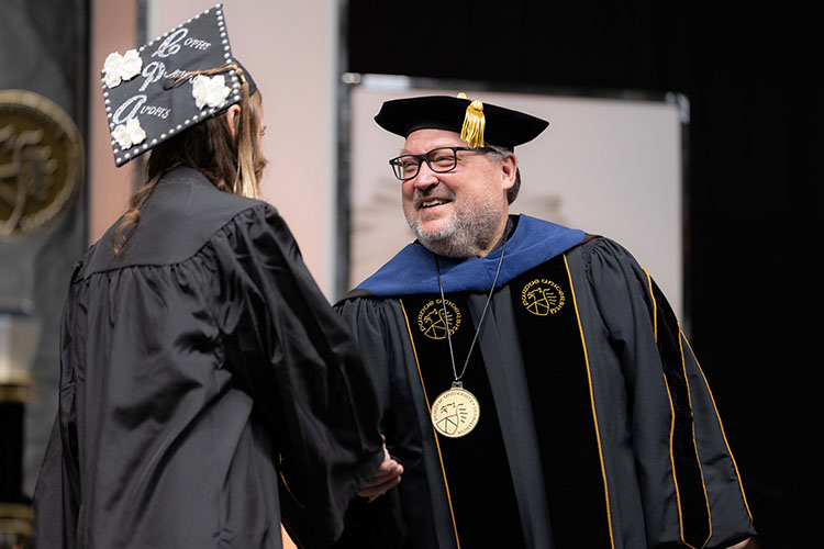 Chancellor Holford congratulates a PNW graduate