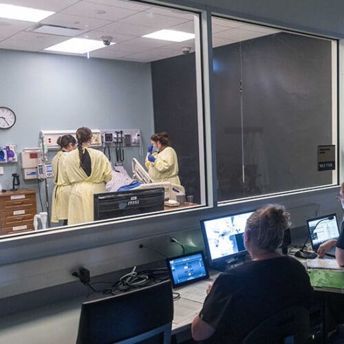 Students work in a nursing simulation lab