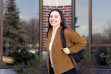 A PNW student poses outdoors on campus