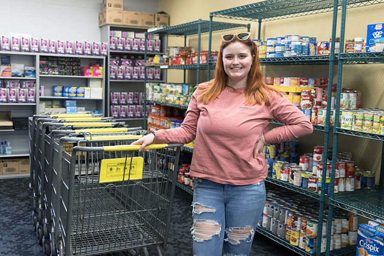 A student stands in the PNW food pantry