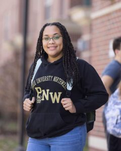 A PNW student poses outdoors