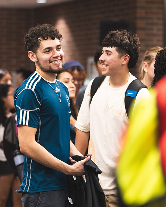 Two students stand together during a welcome rally