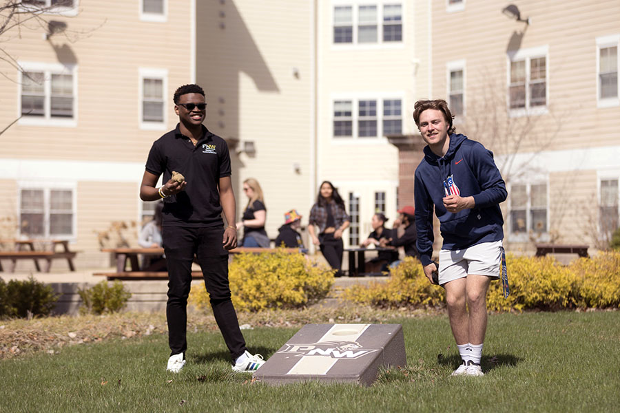 PNW students play beanbag toss outside one of the dorms.