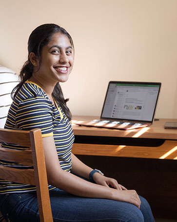 A PNW student sits in her dorm room