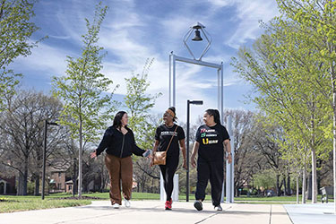 PNW students walk in front of the Bell Tower.