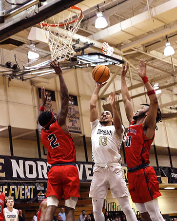 A PNW basketball player drives for a basket.