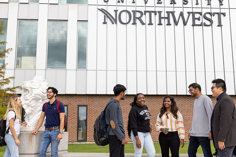 Seven students stand together outdoors