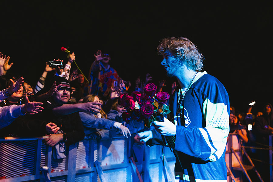 Yung Gravy hands out roses to attendees.