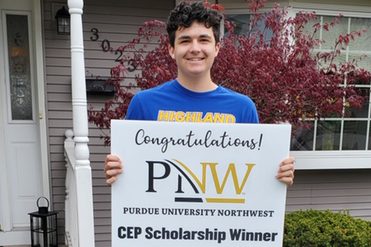 Conner Olah displays a congratulatory sign announcing that he received a scholarship from Purdue Northwest’s Concurrent Enrollment Program.