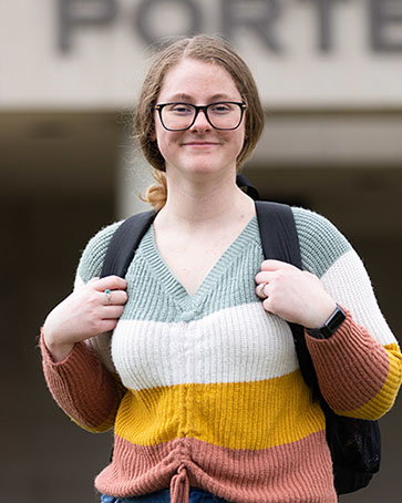 A PNW student outdoors in a sweater