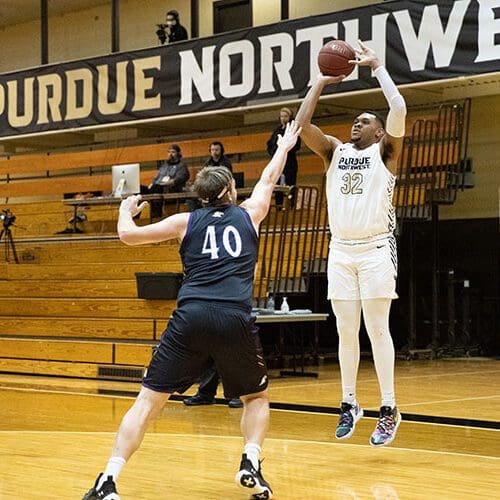 A PNW men's basketball player mid-shot