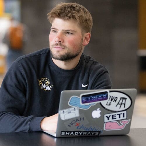 A PNW student works on a laptop