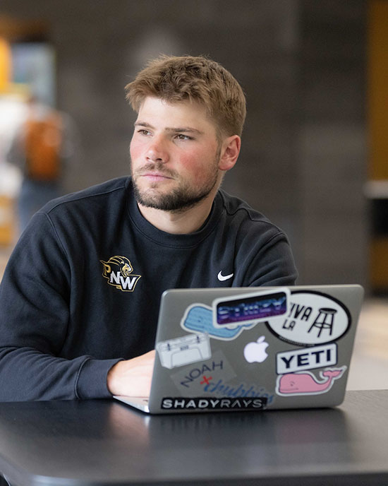 A PNW student works on a laptop